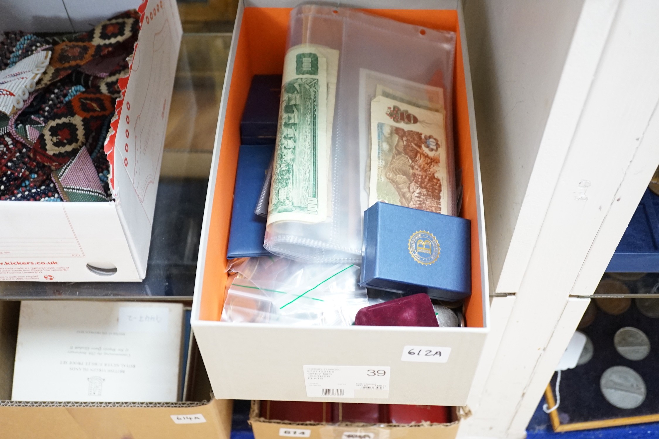 A box of UK and world coins and banknotes, a masonic steel fob seal and a Victorian brass belt buckle